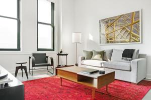 a living room with a couch and a coffee table at Abode Pittsburgh - Downtown Convention Center in Pittsburgh