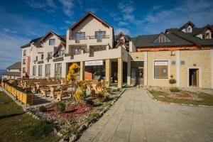 a building with tables and chairs in front of it at Milmari MINART S40 in Kopaonik
