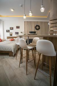 a dining room with a table and white chairs at Milmari MINART S40 in Kopaonik