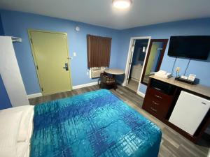 une chambre d'hôtel avec un lit et une télévision dans l'établissement Red Carpet Inn & Suites Wrightstown, à Wrightstown