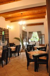 a restaurant with tables and chairs in a room at Vila Bradet in Buşteni