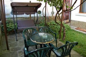a table and chairs with a table and an umbrella at Guest Rooms Toni & Miro in Tryavna