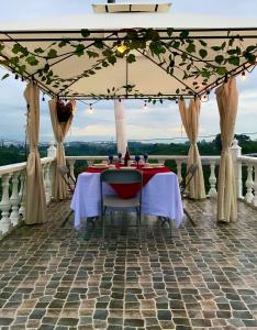 a table in a gazebo on a patio at Castillo Del Toro in Armenia +16 photos
