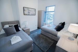 a living room with two beds and a couch at Corpa Heights in Newport