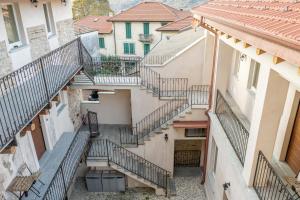 an overhead view of a group of stairs between buildings at La Posteria by iCasamia in Orino