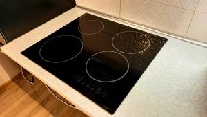 a black stove top oven in a kitchen at M&M Apartment VII Self CHECK-IN in Panevėžys +16 photos