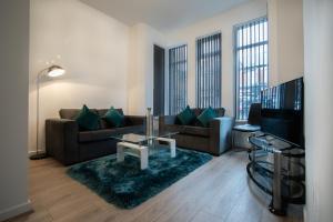 a living room with a couch and a tv at Corpa Retreat in Newport