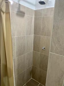 a bathroom with a shower with a glass door at Cabaña hotel conde in Doradal