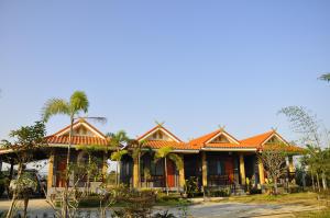 a house with an orange roof at Chiang Rai Khuakrae Resort in Chiang Rai