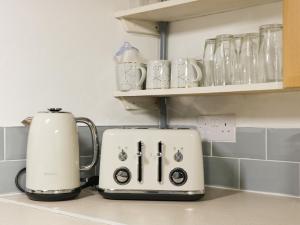 a toaster and coffee maker sitting on a kitchen counter at Hook's House in Scarborough