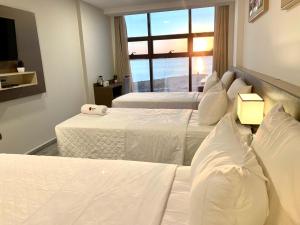 Ліжко або ліжка в номері Hotel Sun