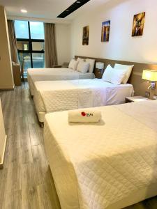 Ліжко або ліжка в номері Hotel Sun