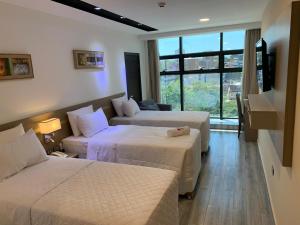 Ліжко або ліжка в номері Hotel Sun