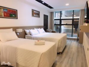 Ліжко або ліжка в номері Hotel Sun
