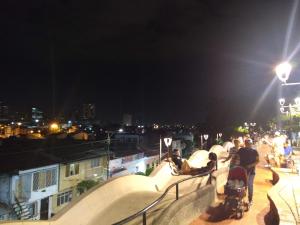 a group of people on a balcony at night at Aché Home Experience in Cali