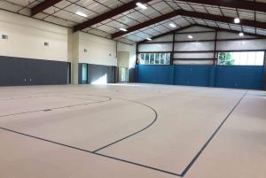an empty gym with a basketball court in a building at Travelodge by Wyndham Panama City Beach / Beachfront in Panama City Beach