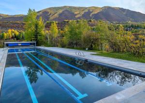a swimming pool with mountains in the background at Aspen Meadows Resort in Aspen