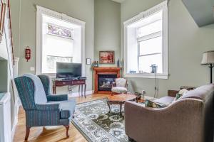 a living room with two chairs and a fireplace at School House Bed and Breakfast C.1859 in Niagara on the Lake