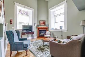 a living room with two chairs and a fireplace at School House Bed and Breakfast C.1859 in Niagara-on-the-Lake