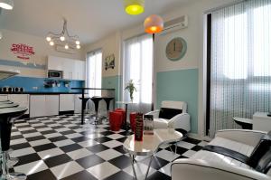 a kitchen and living room with a checkered floor at Far Home Plaza Mayor in Madrid