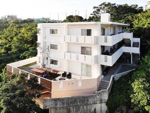 a large white building on top of a hill at Green Garden Hills 3F-2 in Okinawa City