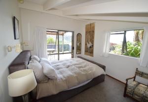 a bedroom with a large bed and a window at Marahau Retreat in Marahau