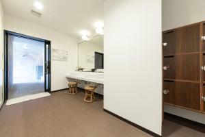 a room with a bathroom with a sink and a desk at Hotel Just One Susono in Susono