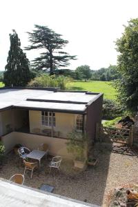 a small house with a table and chairs in front of it at The Coach House in Bristol