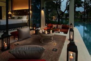 une chambre d'hôtel avec un lit et une piscine dans l'établissement Grand Mercure Khao Lak Bangsak, à Khao Lak