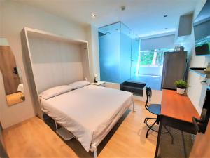 a bedroom with a bed and a desk and a window at International Service Apartments at Raeburn Park in Singapore