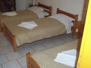 A bed or beds in a room at Hotel Elytis