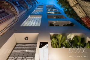 a collage of photos of a building with plants at Bare Chic - Bare Boutique Stays in Ho Chi Minh City
