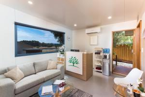 a living room filled with furniture and a tv at The Swan Valley Retreat in Henley Brook