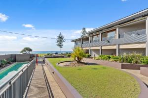 a house with a swimming pool next to the ocean at Sea Salt - Lennox Head in Lennox Head