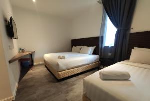Postel nebo postele na pokoji v ubytování T Hotel Tandop