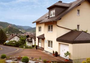 a house with a black roof on a street at Ferienhaus Am Reilsbach in Cochem