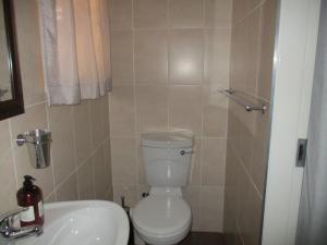 a bathroom with a toilet and a sink at White Rose Guest House in Vanderbijlpark +25 photos