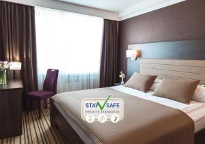 Postel nebo postele na pokoji v ubytování Premier Hotel Rus