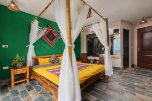 a bedroom with a bed and a green wall at Mega View Homestay in Sapa