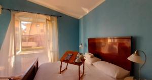 a bedroom with a bed with a table and a window at Fabiola B & B in Marino