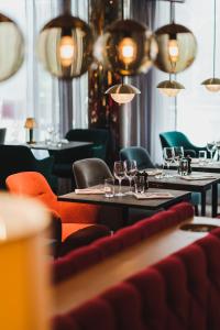 a restaurant with tables and chairs with glasses on them at Hotel Rival in Stockholm