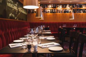 a long table in a restaurant with glasses on it at Hotel Rival in Stockholm
