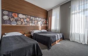 Postel nebo postele na pokoji v ubytování Hotel History • სასტუმრო ისტორია