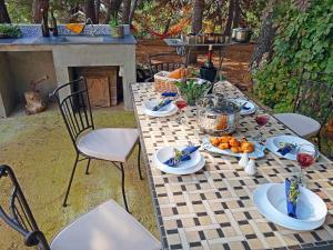 a table with plates of food on top of it at Quercus Apartment in Stara Baška