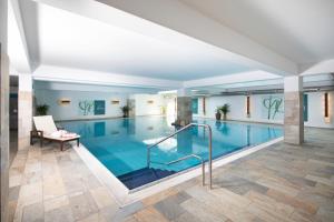 a large swimming pool in a building at Kirchenwirt in Reith im Alpbachtal