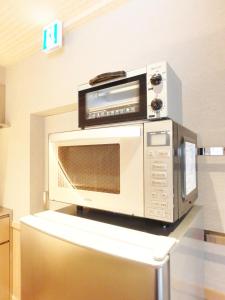 a microwave oven sitting on top of a table at Gion Suite in Kyoto +28 photos