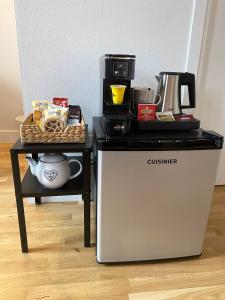 a table with a coffee maker on top of a refrigerator at Lavagnini My Place B&B in Florence
