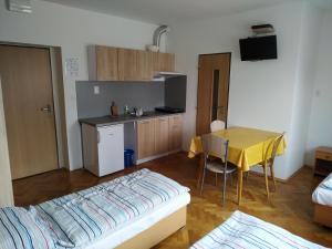 a kitchen with a table and a yellow table cloth at Garsónky v rodinnom dome Nitra-Lužianky in Nitra