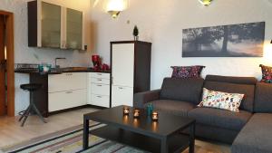 a living room with a couch and a table at Hotel und Restaurant Bommersheim in Eschborn