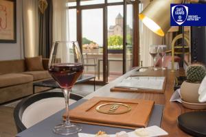 a glass of wine on a table in a living room at Tiflis Palace in Tbilisi City